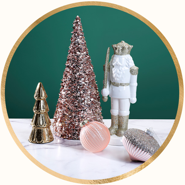 Golden Christmas tree figurine, glitter ornaments, and a white & gold nutcracker.