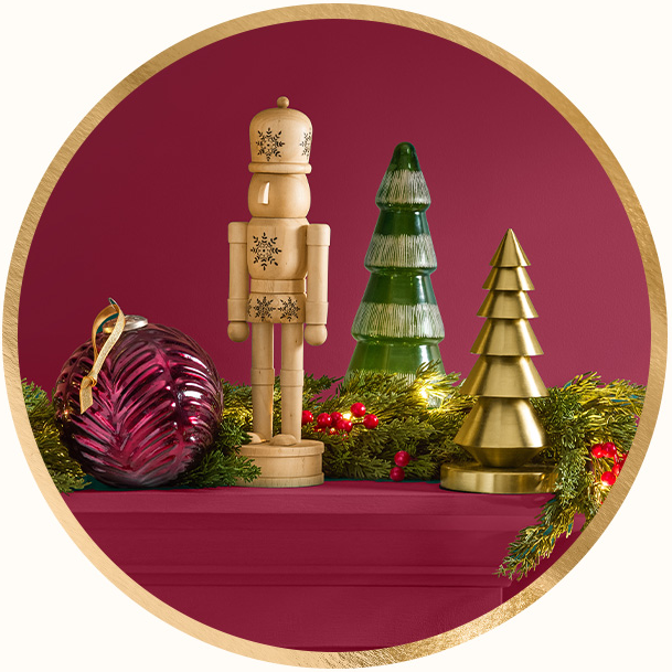 Glass ornaments, a wooden nutcracker & Christmas tree figurines.